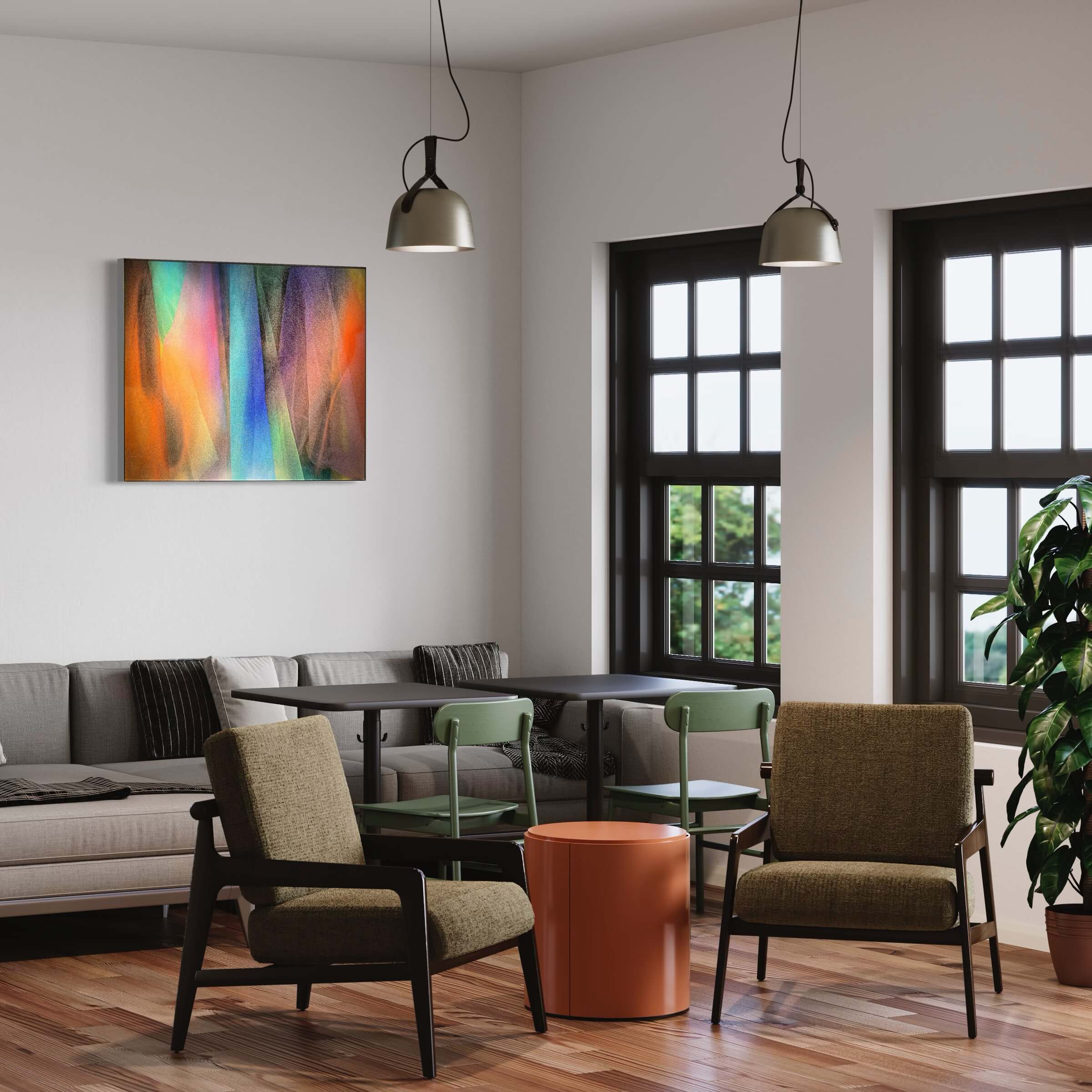 This is a modern room with the "Emotional Spectrum" on the wall. There's a gray sofa, stylish chairs, and a copper table. Light from the windows fills the space, and two lamps hang from the ceiling.